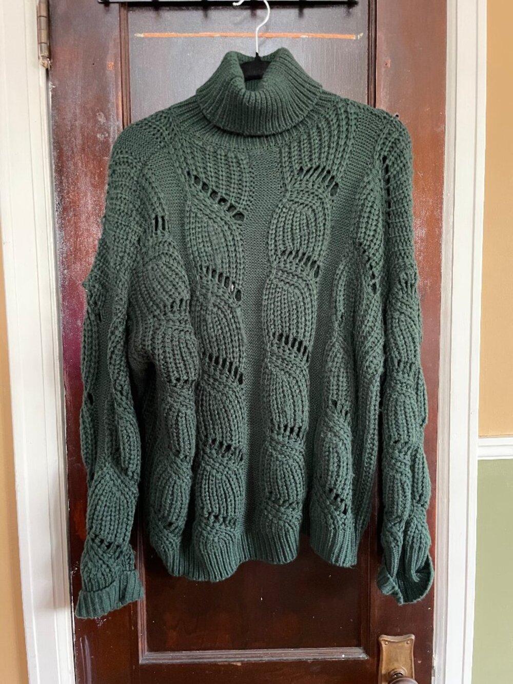 Dark green cable-knit turtleneck sweater